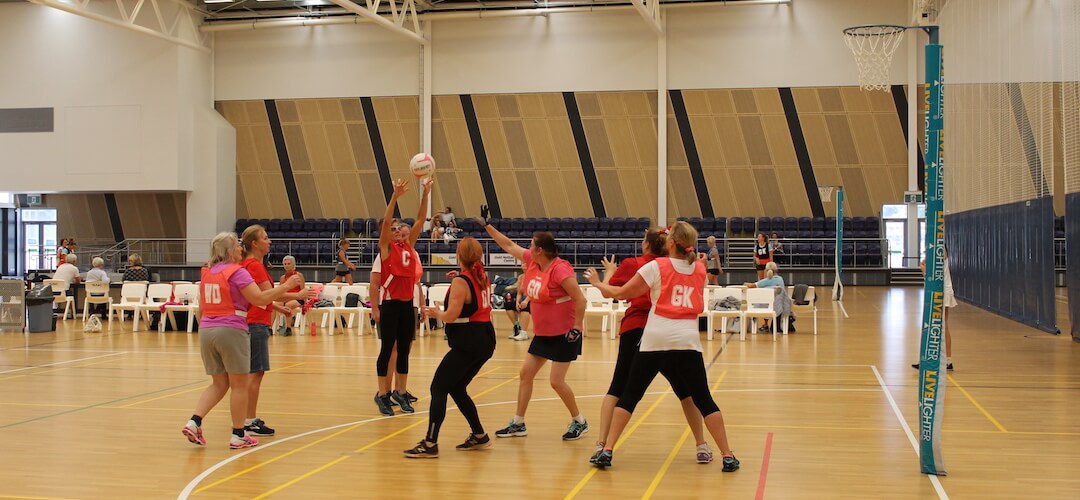 a netball team playing near the D on court