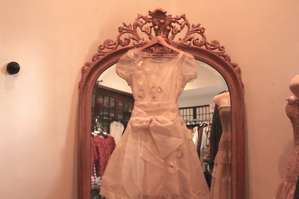 A Silk Vintage Wedding dress in front of a full sized mirror