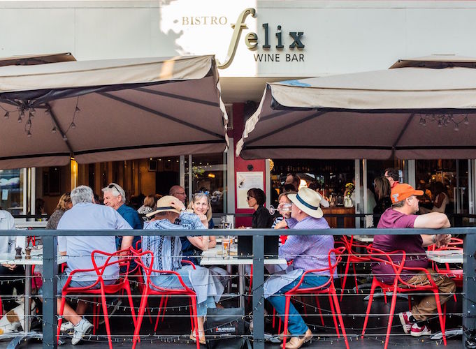 group of people sitting in alfresco area of Bistro Felix drinking and eating