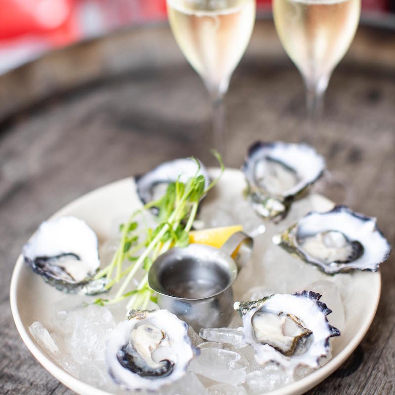 a plate of oysters and two glasses of champagne