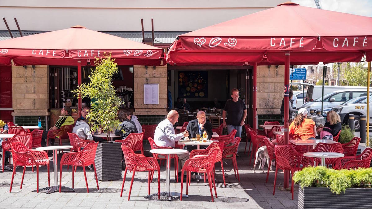 outdoor area at cafe cafe showing people eating and dogs