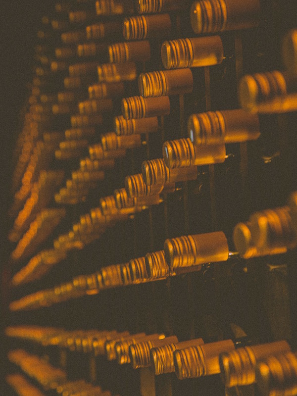 wine bottles on gold bar wall