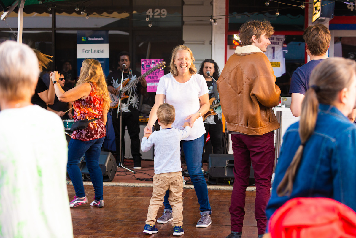 A woman dances in the Subiaco pop up square with her young grandson, they are laughing together